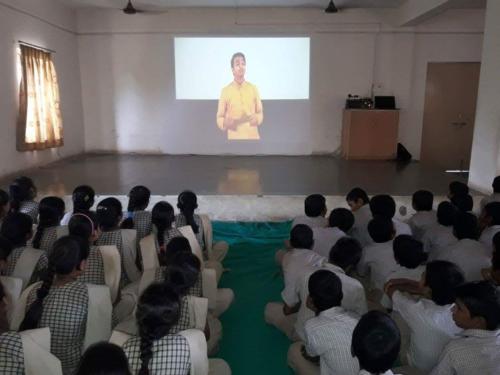 Students in Gujarat watching ROSHNI Founder Pravin Nikam speaking on Menstrual Hygiene